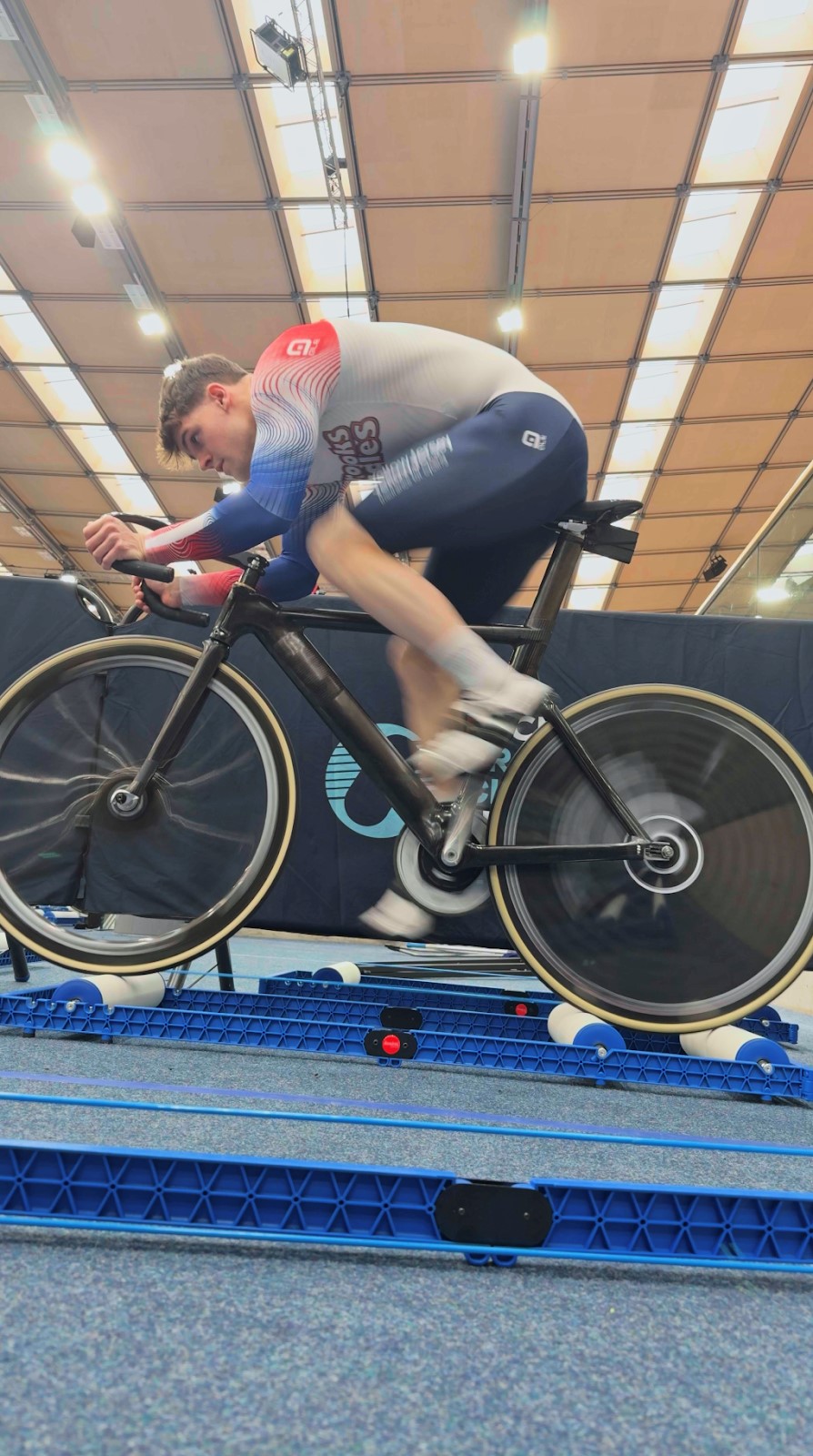 A track cyclist warming up on the rollers